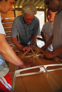 Paul guides the construction of a hollow wooden board
